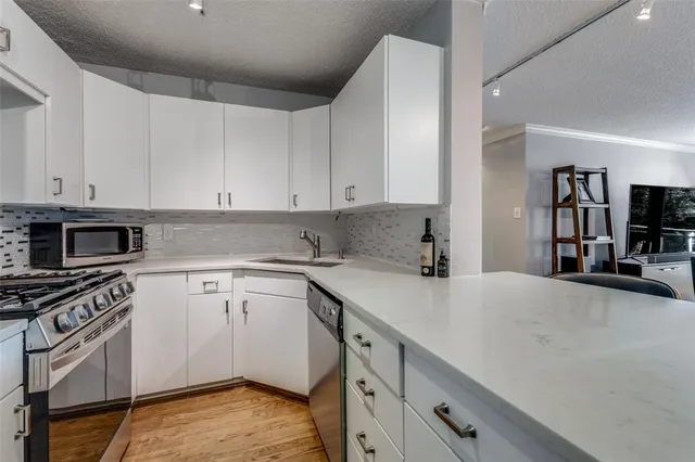 a kitchen with a sink cabinets and appliances