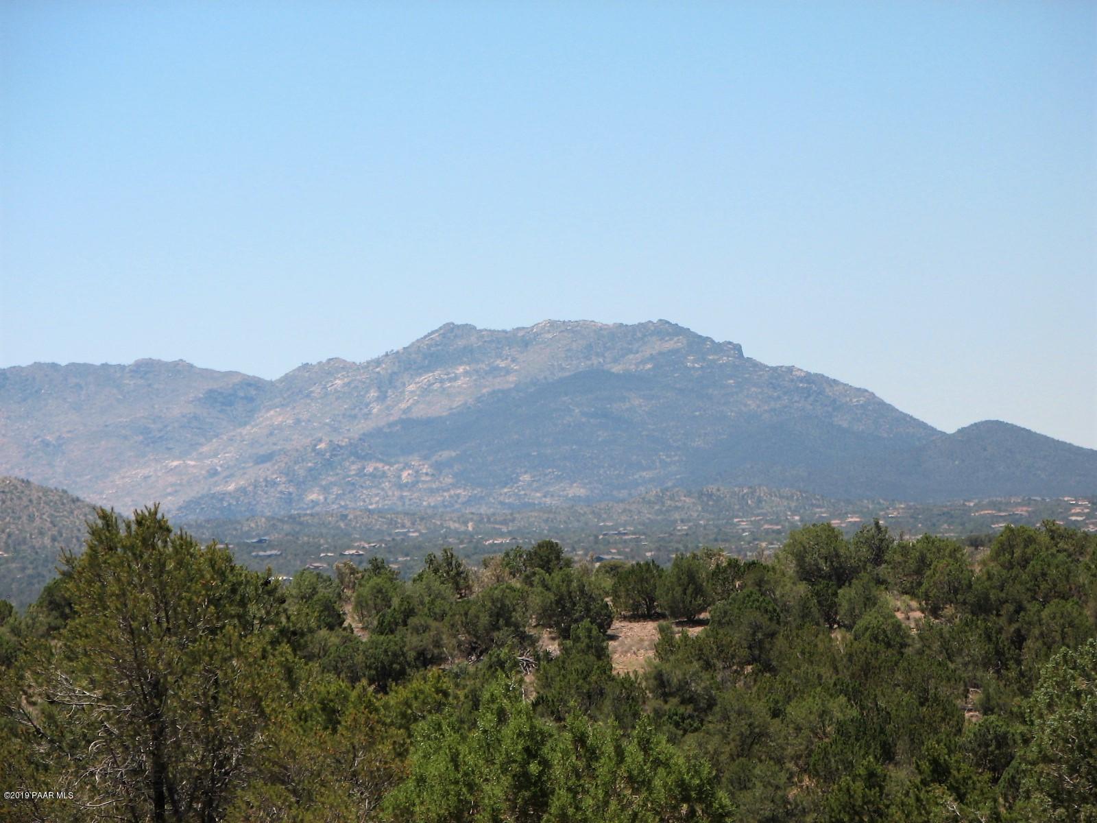 18700 Butte Pass Road Prescott, AZ 86305 - Photo 41 of 43 a view of a lush green field with mountains in the background