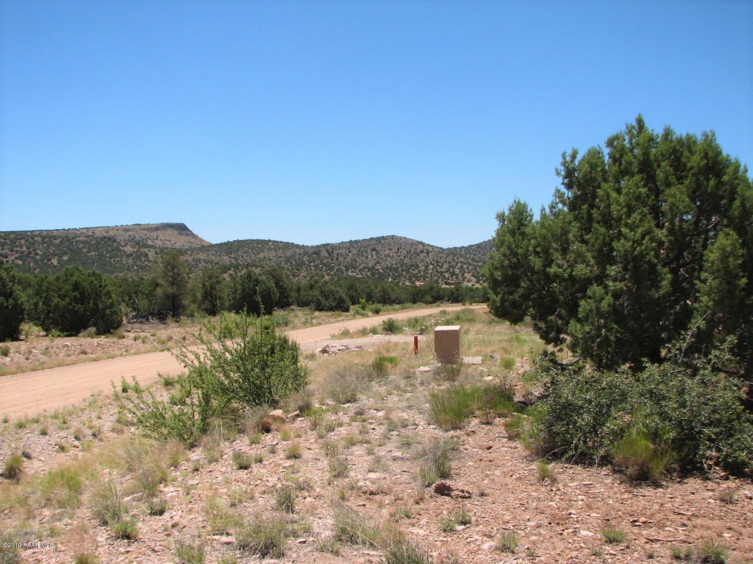 18700 Butte Pass Road Prescott, AZ 86305 - Photo 9 of 43 a view of a lake with mountains in the background