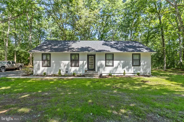 a front view of a house with swimming pool having outdoor seating