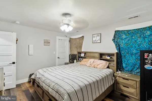 a bedroom with a bed and a dresser