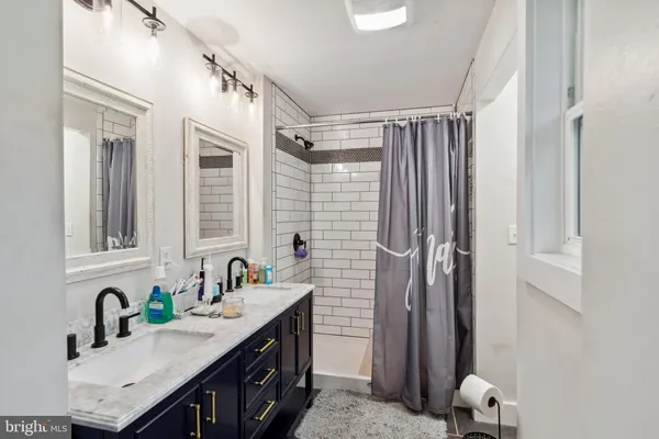 a bathroom with a sink double vanity and a mirror