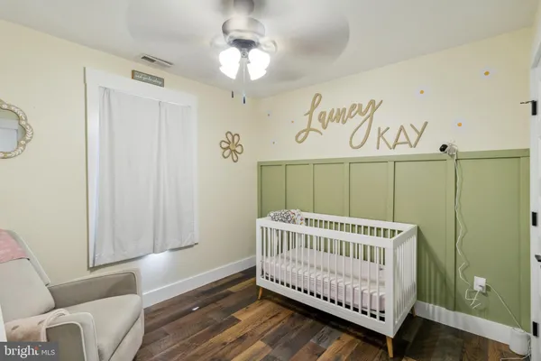 a view of a room with furniture and wooden floor
