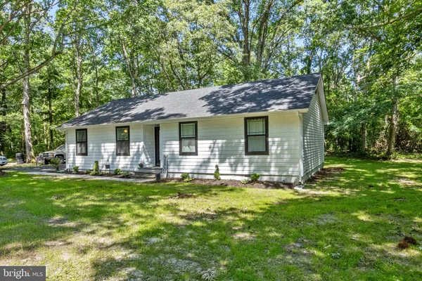 a house view with swimming pool and garden space