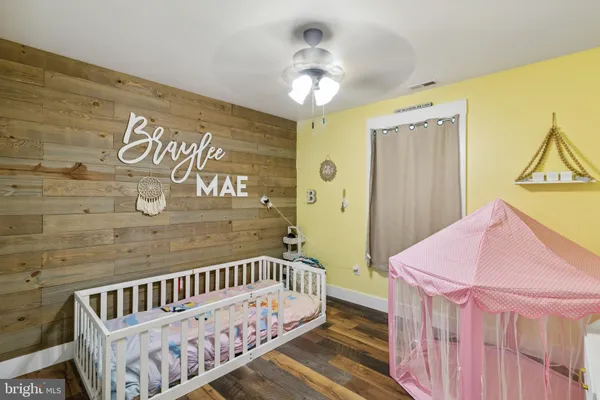 a view of a bedroom with furniture and wooden floor