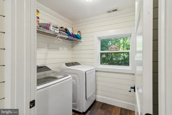 a view of a house with a patio and a yard