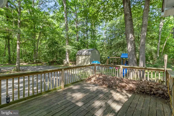 a view of backyard of house with green space