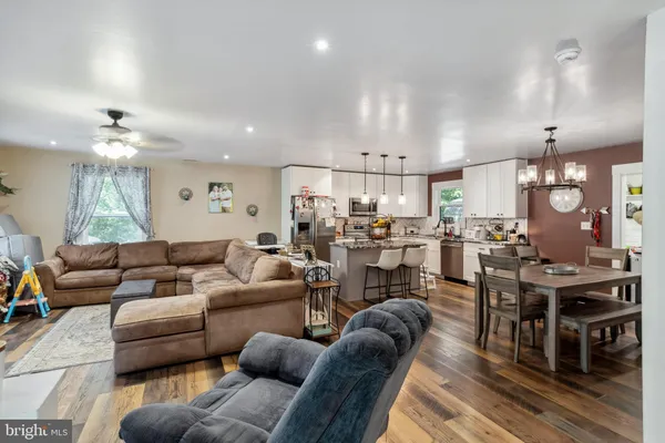 a living room with lots of furniture and kitchen view