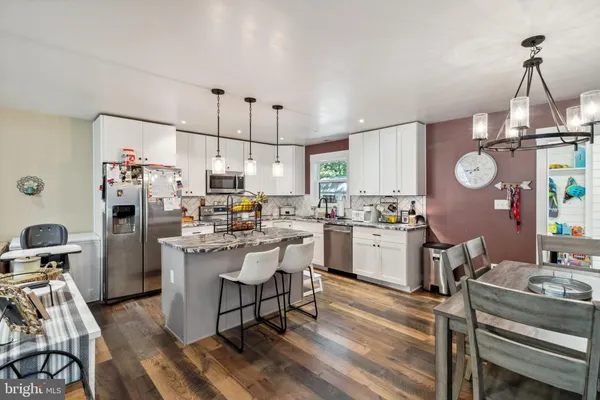 a kitchen with a sink appliances and cabinets