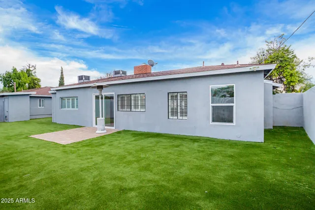 a large kitchen with stainless steel appliances granite countertop a stove a sink and a refrigerator