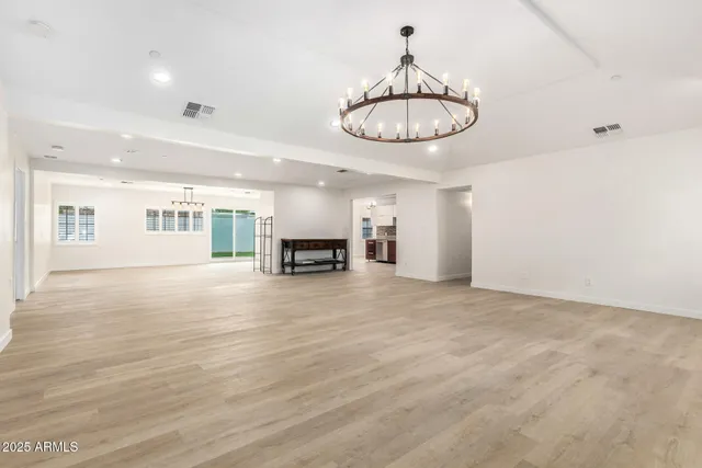 a kitchen with stainless steel appliances granite countertop a sink a stove and a wooden floors