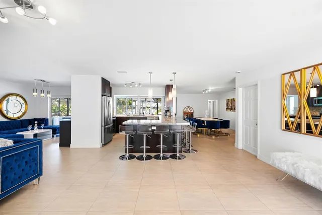 a living room with lots of furniture and painting on the wall
