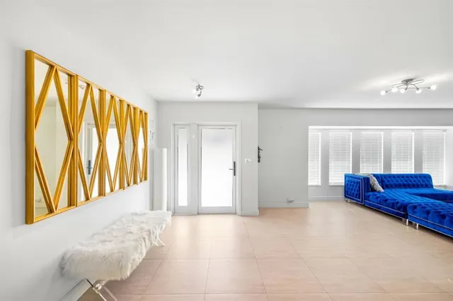 a view of front door with furniture and a window