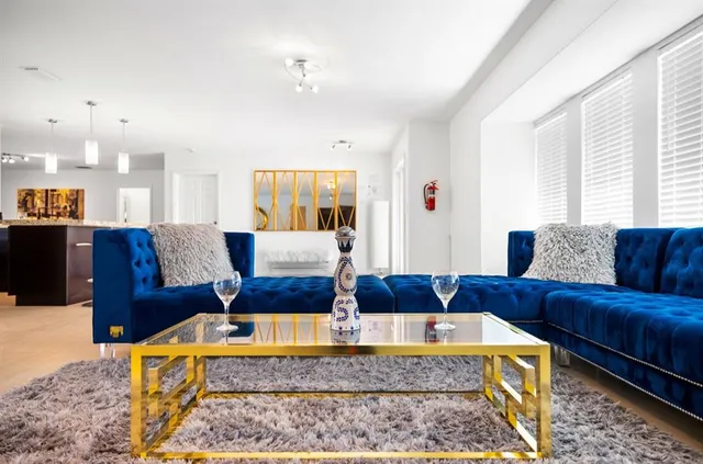 a living room with furniture wooden floor and window