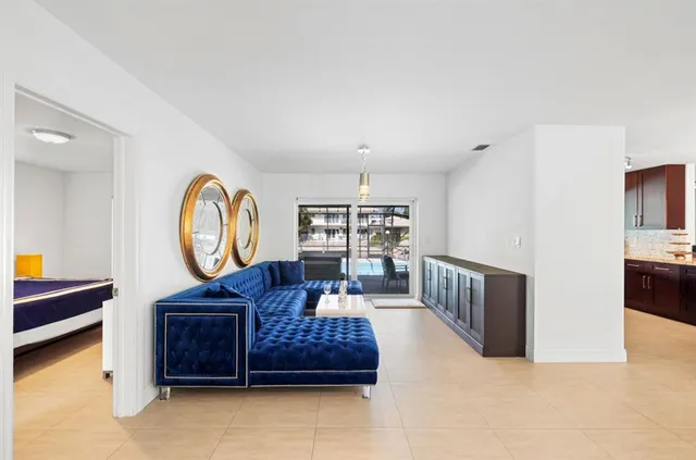 a living room with furniture a rug and a window