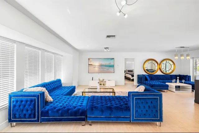 a living room with furniture a air conditioner and a window