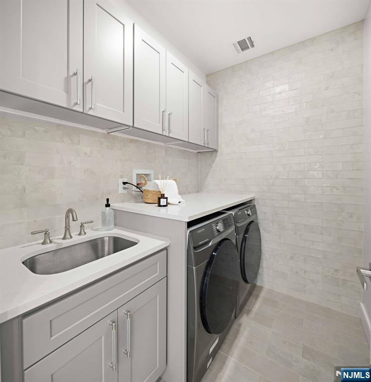 14 Beechwood Road Ho-Ho-Kus, NJ 07423 - Photo 19 of 31 a utility room with sink washer and dryer