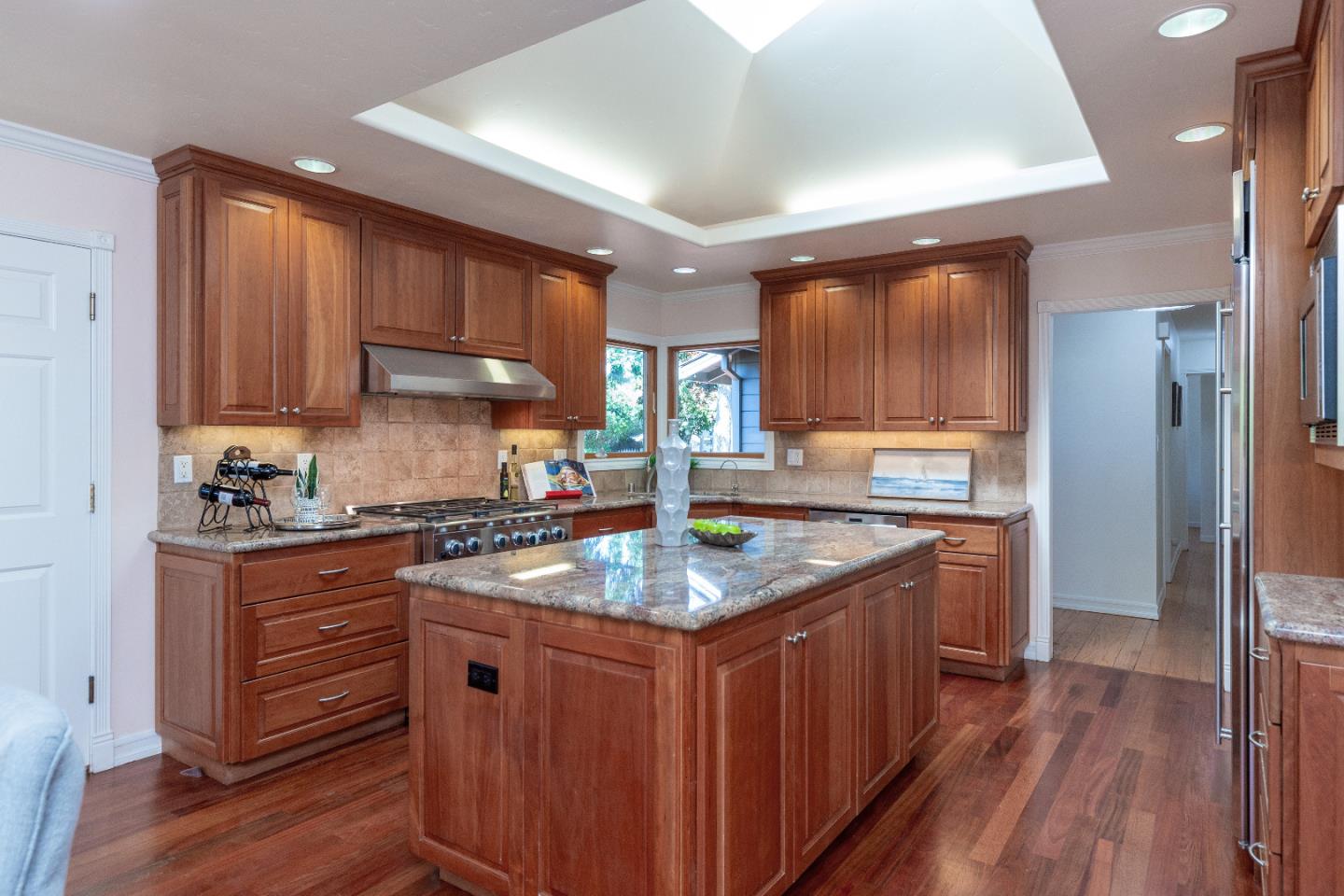 14920 Jerries Drive Saratoga, CA 95070 - Photo 11 of 34 a kitchen with stainless steel appliances granite countertop a stove a sink dishwasher and a refrigerator with wooden floor