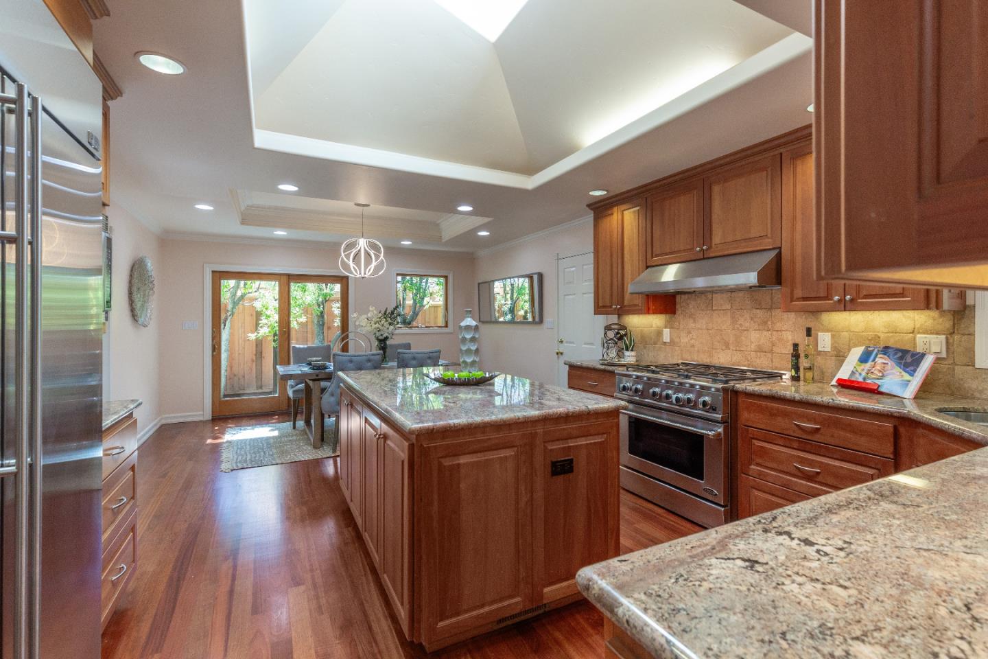 14920 Jerries Drive Saratoga, CA 95070 - Photo 13 of 34 a kitchen with stainless steel appliances granite countertop wooden cabinets a stove top oven a sink and dishwasher