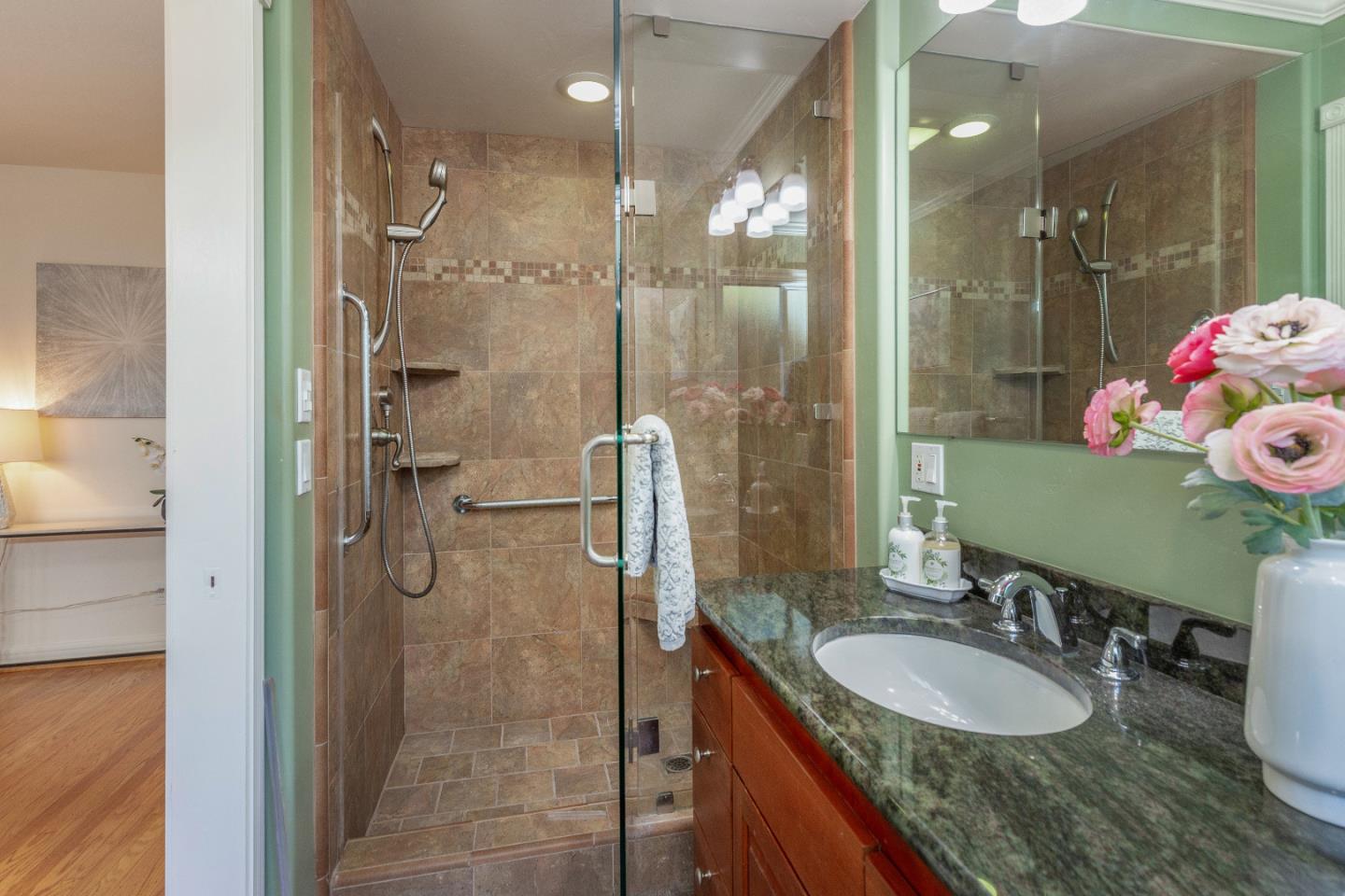 14920 Jerries Drive Saratoga, CA 95070 - Photo 21 of 34 a bathroom with a sink vanity granite shower and a mirror