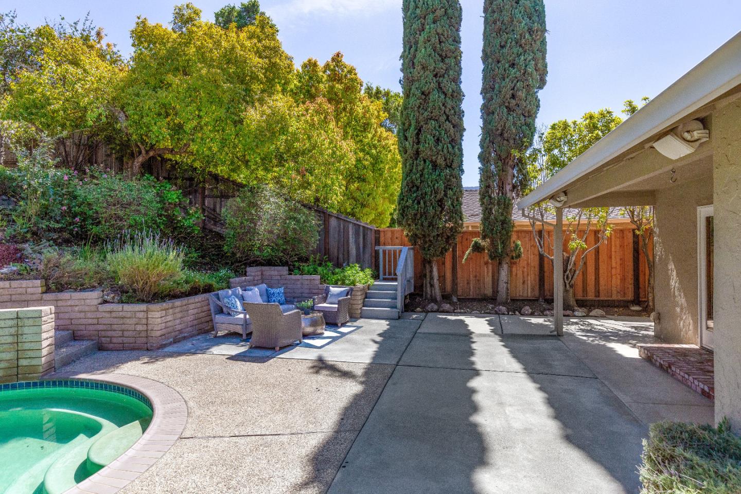14920 Jerries Drive Saratoga, CA 95070 - Photo 30 of 34 a backyard of a house with fountain table and chairs