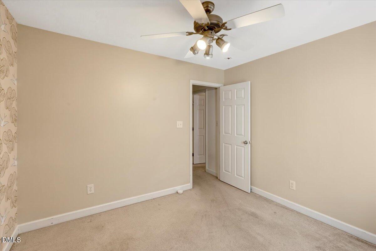 6021 Four Townes Lane Raleigh, NC 27616 - Photo 14 of 22 an empty room with a chandelier fan and closet