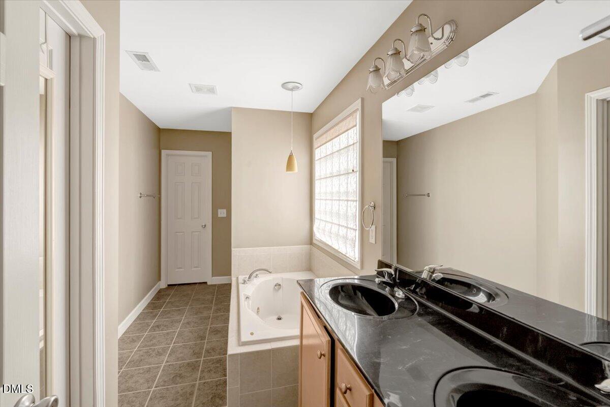 6021 Four Townes Lane Raleigh, NC 27616 - Photo 17 of 22 a bathroom with a sink and a mirror