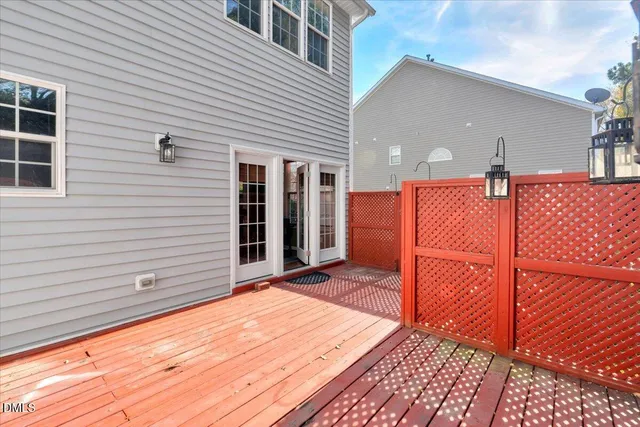 a backyard of a house with wooden floor and fence