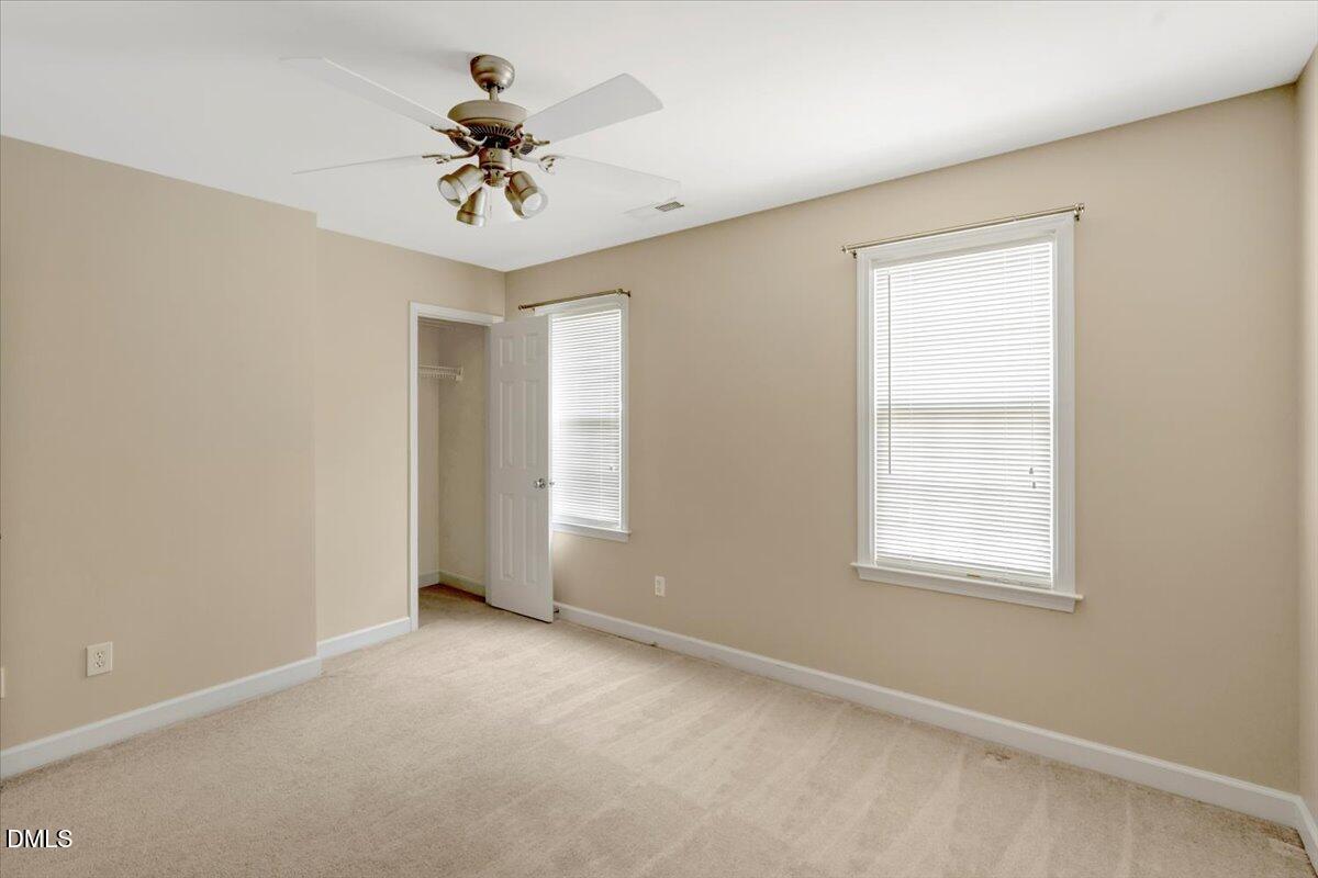 6021 Four Townes Lane Raleigh, NC 27616 - Photo 28 of 49 an empty room with a window and a ceiling fan