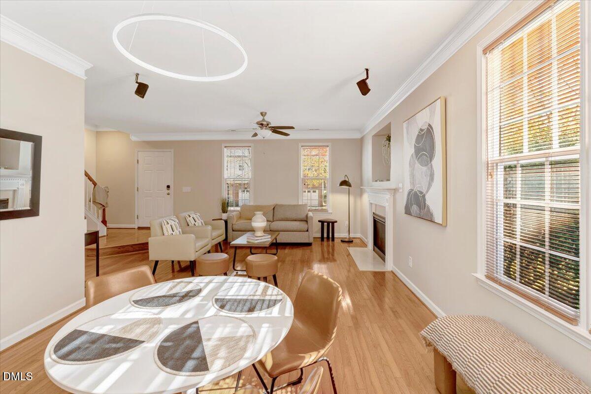 6021 Four Townes Lane Raleigh, NC 27616 - Photo 3 of 22 a living room with furniture a dining table and a large window