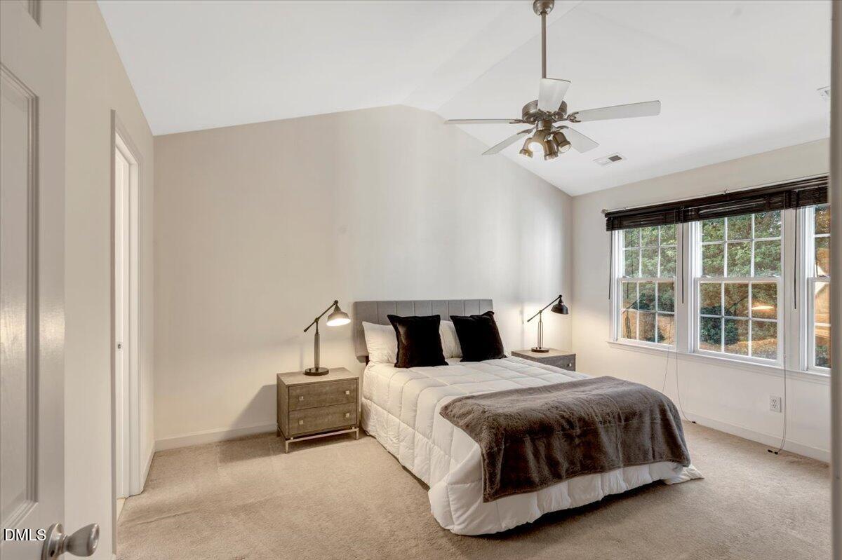 6021 Four Townes Lane Raleigh, NC 27616 - Photo 37 of 49 a bedroom with a bed chandelier and window