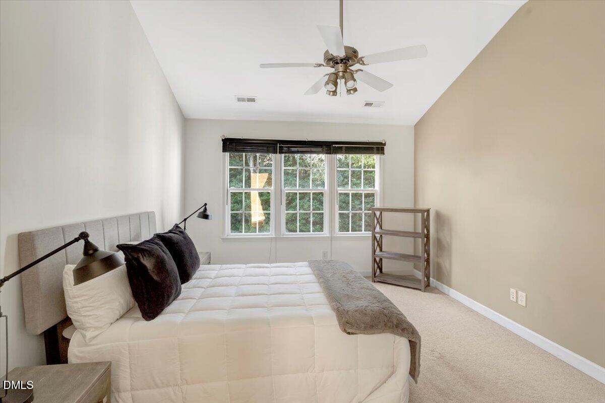 6021 Four Townes Lane Raleigh, NC 27616 - Photo 38 of 49 a bedroom with a bed and glass window