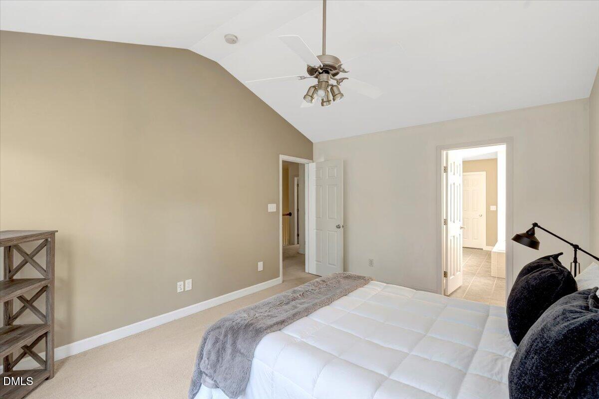 6021 Four Townes Lane Raleigh, NC 27616 - Photo 40 of 49 a bedroom with a bed and a chandelier