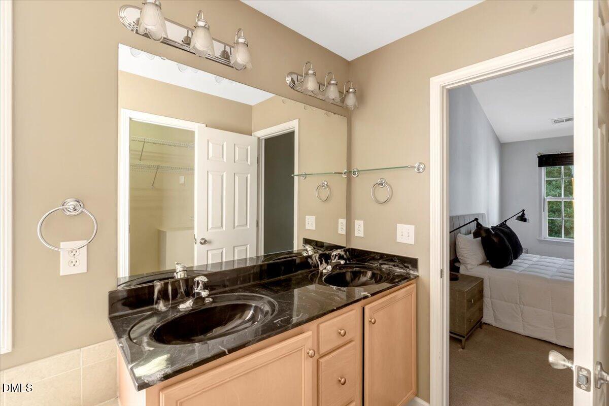 6021 Four Townes Lane Raleigh, NC 27616 - Photo 44 of 49 a bathroom with a sink and a mirror