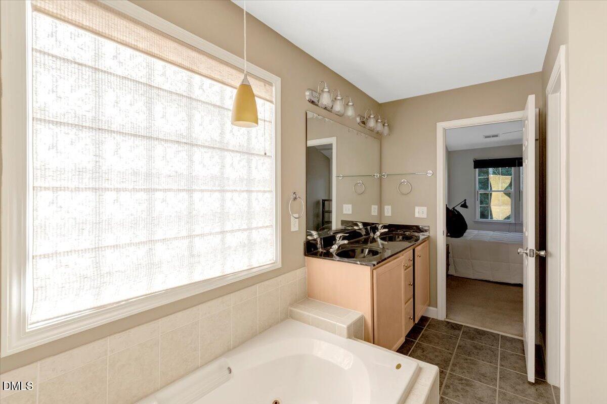 6021 Four Townes Lane Raleigh, NC 27616 - Photo 46 of 49 a kitchen with a stove a refrigerator and a window
