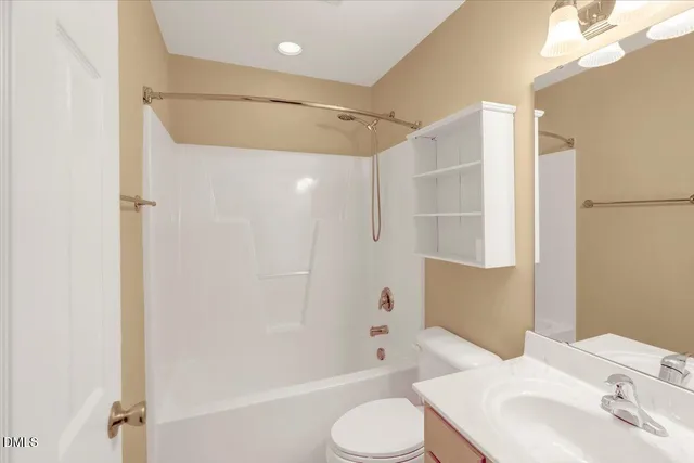 a bathroom with a shower curtain and a sink