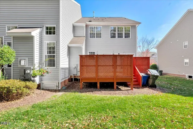 a backyard of a house with barbeque oven table and chairs