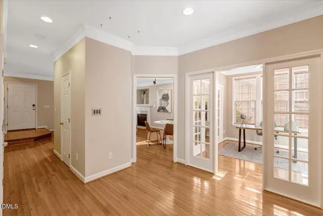 a view of a livingroom with wooden floor and a kitchen