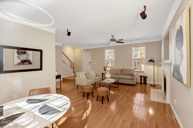 a living room with furniture and a wooden floor