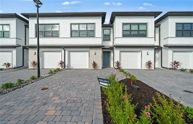 a front view of a house with a yard and a garage