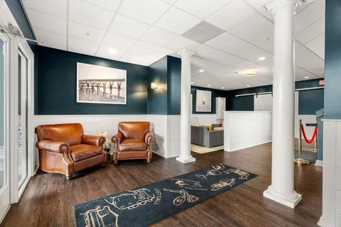 a hallway with furniture and wooden floor