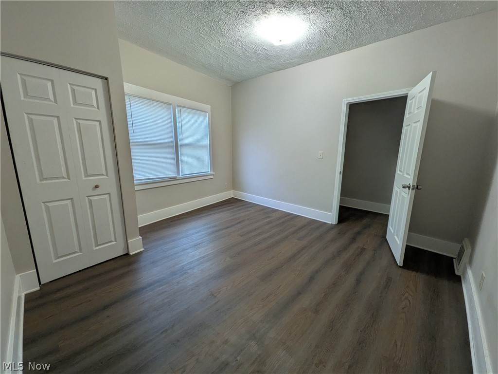 1881 Manchester Road, Unit 1 Akron, OH 44314 - Photo 8 of 44 1881 Manchester Rd, Akron, OH 44314 Unit #1 ground floor access and living. Welcome to this spacious 2-bedroom, 1-bathroom first-floor generous and remodeled apartment in the Kenmore neighborhood of Akron, offering a great amount of comfortable living space. This move-in ready apartment features LVP flooring throughout, a spacious living room, room for dining, separate kitchen with a gas range and stainless steel refrigerator, two bedrooms, and a full private bathroom which has a convenient step-in shower. Large windows provide natural light, while ample closets offer plenty of storage. Enjoy off-street parking and a backyard with a picnic table and small firepit, providing a pleasant outdoor space to relax and enjoy for the buildings tenants.