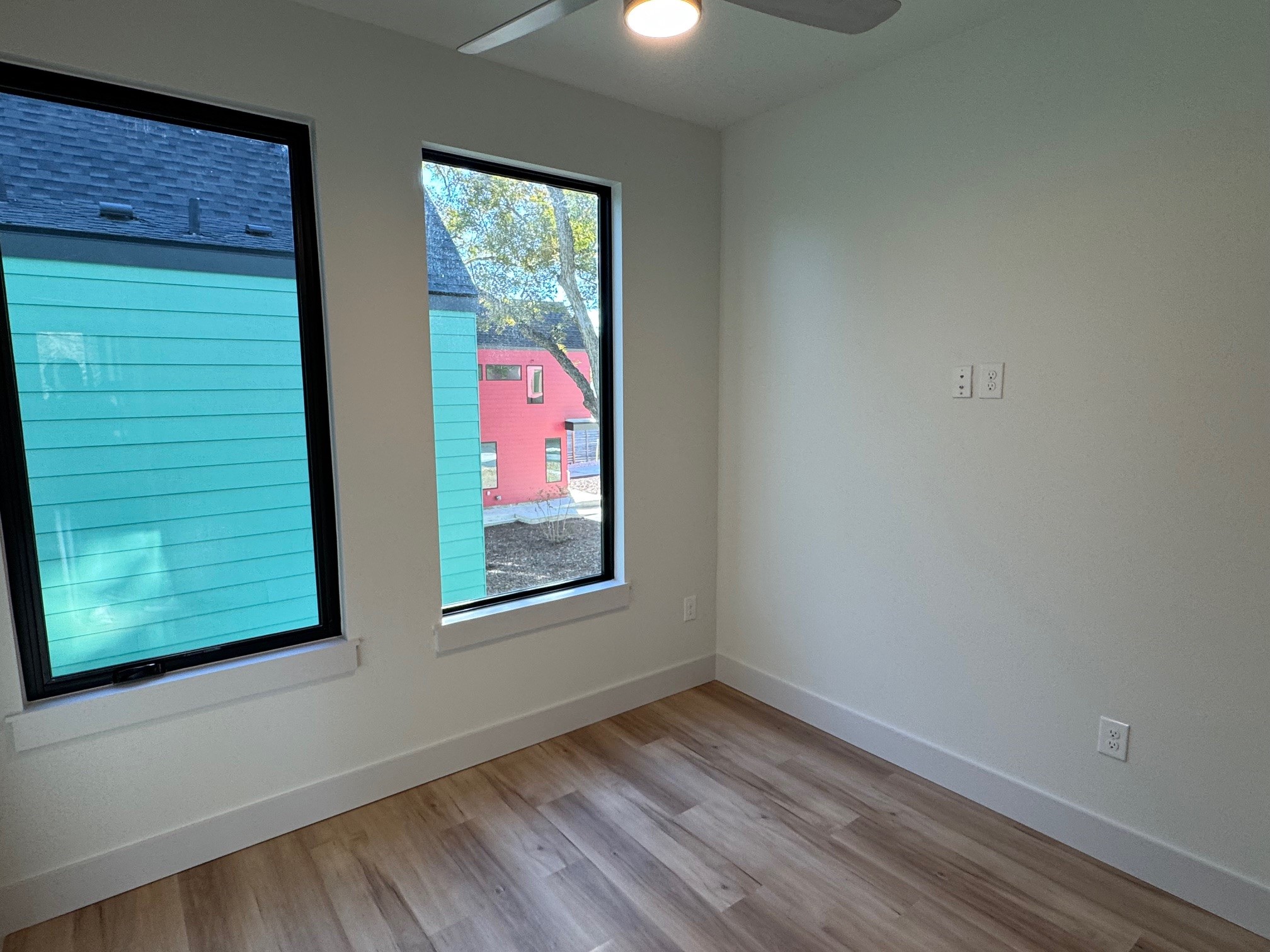 1131 Walton Lane, Unit 3 Austin, TX 78721 - Photo 11 of 16 a view of an empty room with a window and wooden floor
