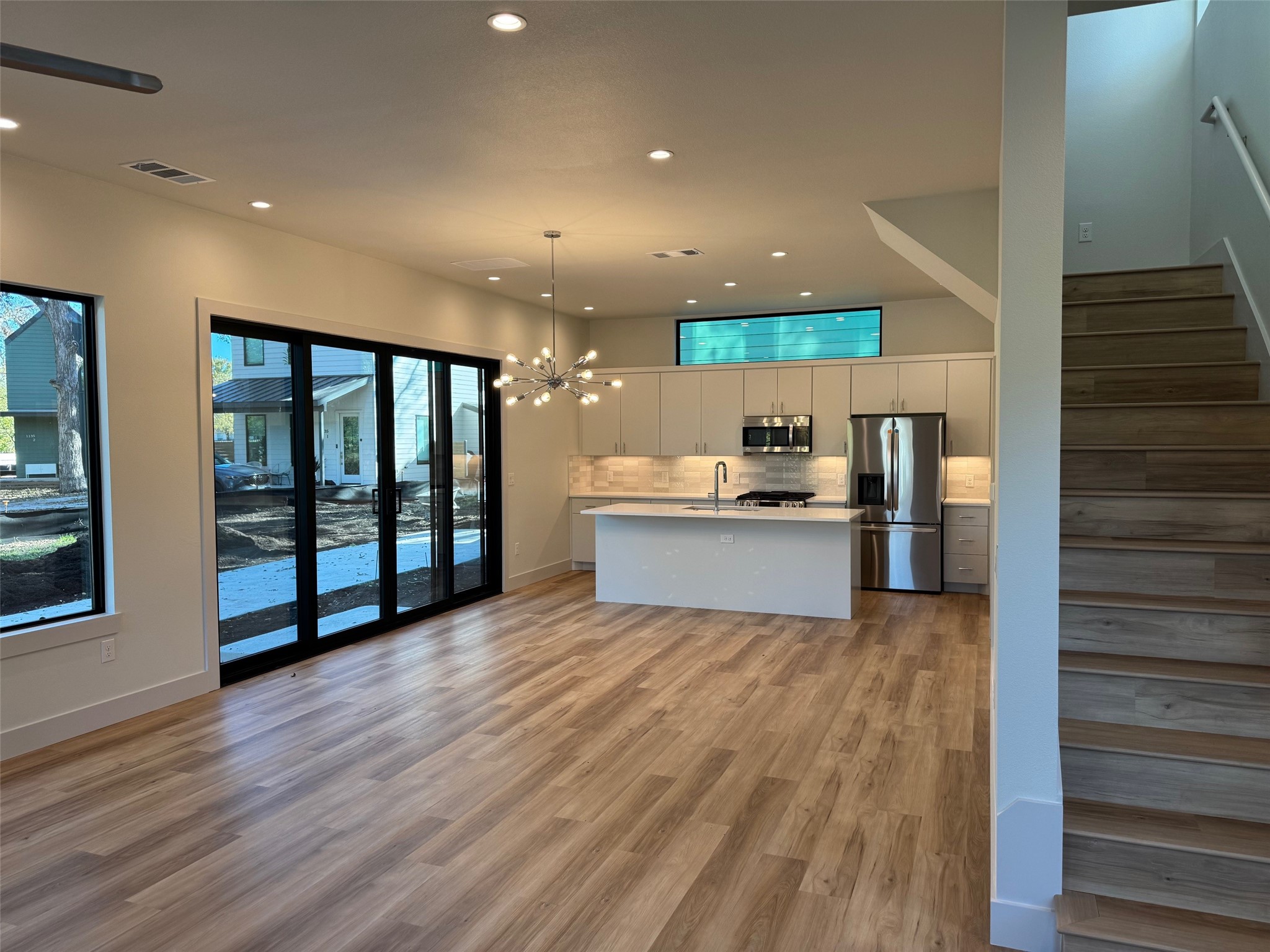 1131 Walton Lane, Unit 3 Austin, TX 78721 - Photo 2 of 16 a view of kitchen with stainless steel appliances kitchen island wooden floor and window