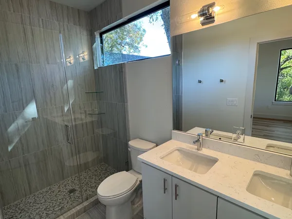 a bathroom with a sink toilet and shower