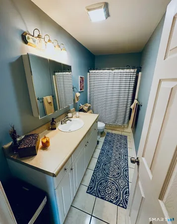 a bathroom with a sink toilet and mirror