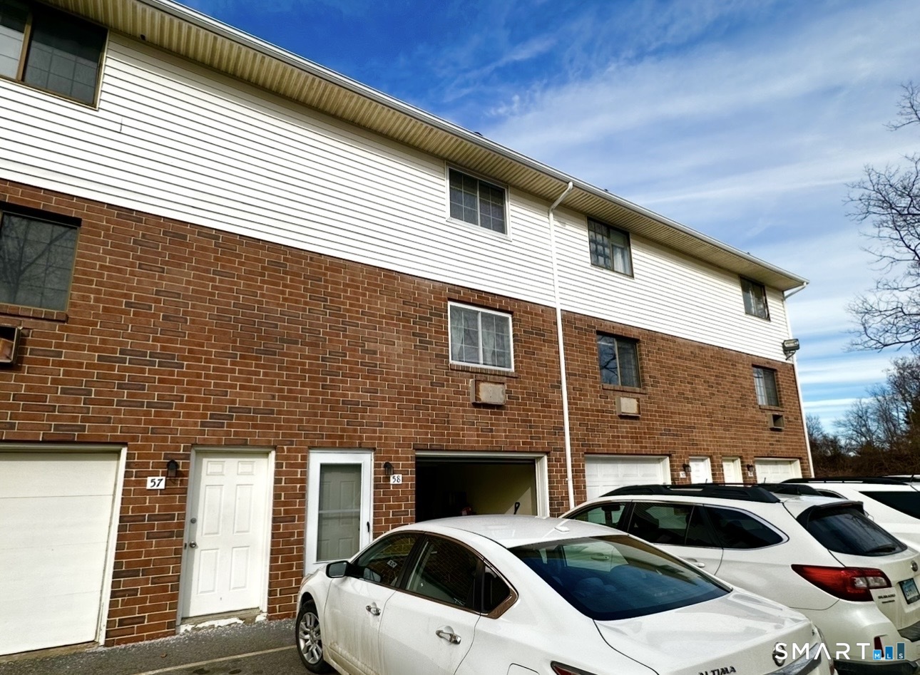 519 Scott Road, Unit 58 Waterbury, CT 06705 - Photo 19 of 19 a front view of a house with parking space