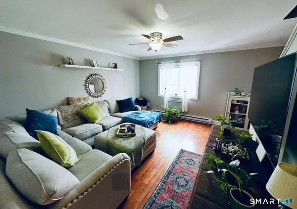 a living room with furniture and a flat screen tv