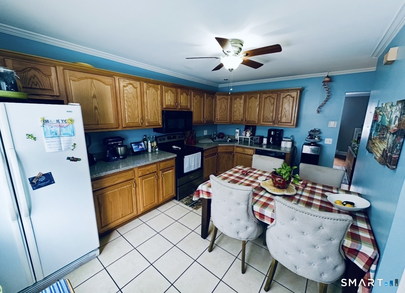 519 Scott Road, Unit 58 Waterbury, CT 06705 - Photo 5 of 19 a very nice looking open kitchen with stainless steel appliances granite countertop a refrigerator a sink a stove a dining table and chairs with wooden floor