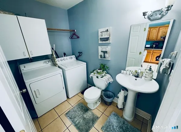 a bathroom with a sink toilet and mirror